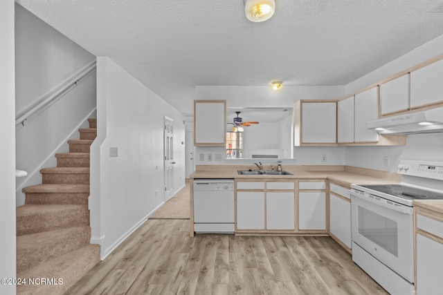 kitchen featuring white appliances, a textured ceiling, sink, and light wood-type flooring