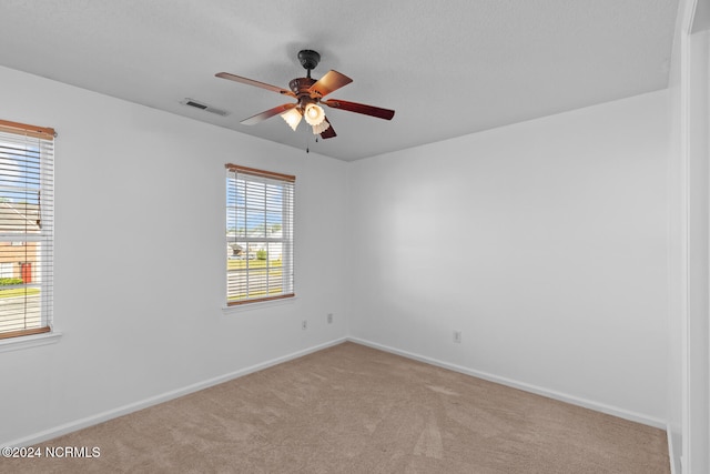 empty room with light carpet and ceiling fan