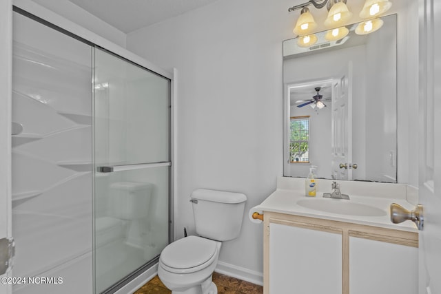 bathroom featuring a shower with door, vanity, toilet, and ceiling fan