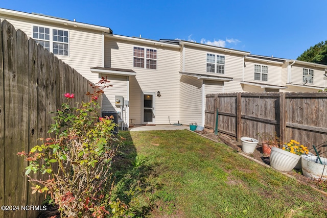 back of property featuring a patio and a lawn