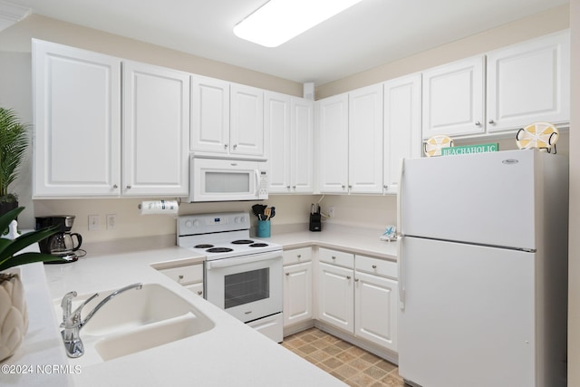 kitchen with sink, white cabinets, and white appliances