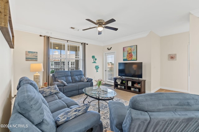 living room with ceiling fan and ornamental molding