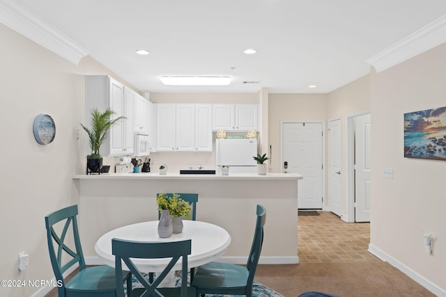 kitchen featuring ornamental molding, white cabinetry, kitchen peninsula, and white appliances