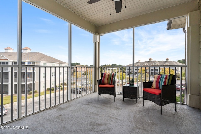 sunroom / solarium with ceiling fan and wooden ceiling