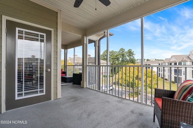 unfurnished sunroom with ceiling fan