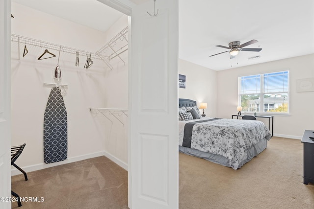 bedroom featuring light carpet and ceiling fan