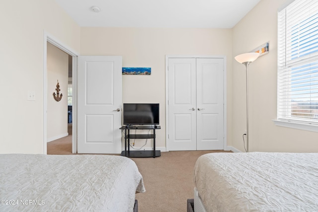 carpeted bedroom with a closet