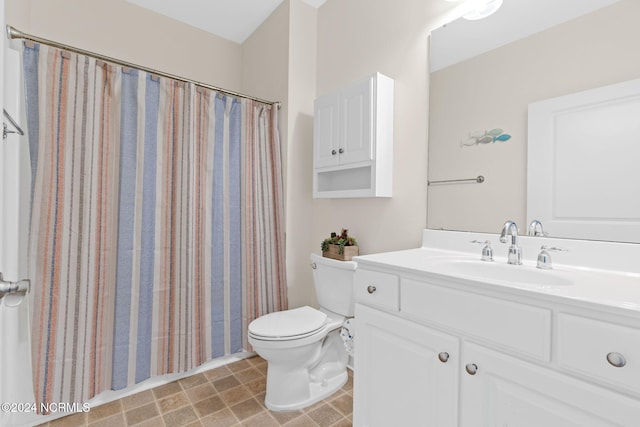 bathroom featuring vanity, toilet, and curtained shower