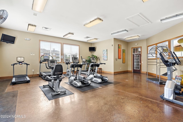 exercise room featuring concrete flooring