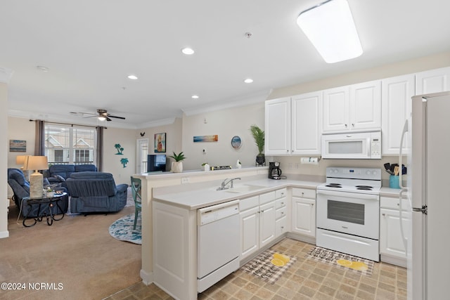 kitchen featuring white appliances, crown molding, white cabinetry, and kitchen peninsula