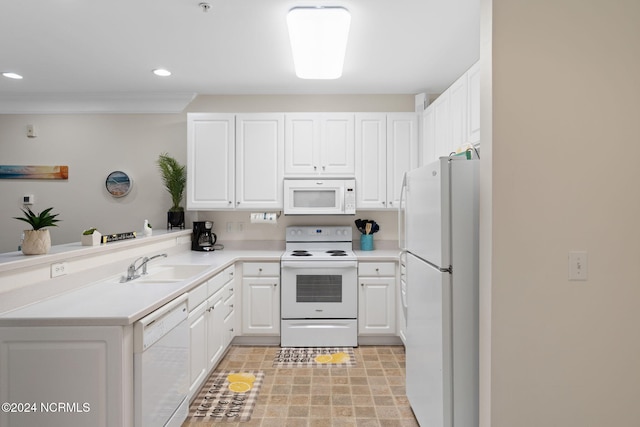 kitchen featuring sink, white cabinets, kitchen peninsula, and white appliances