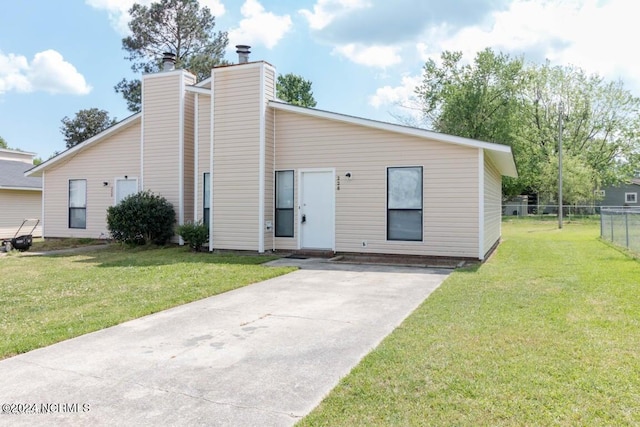 rear view of house featuring a lawn