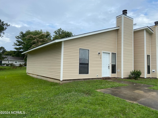 back of property featuring a yard