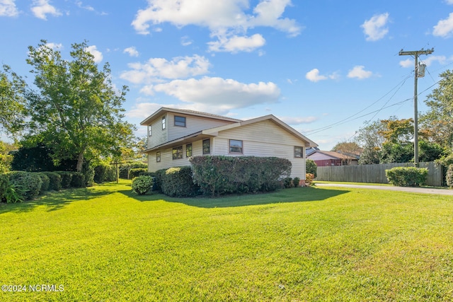 view of property exterior featuring a lawn