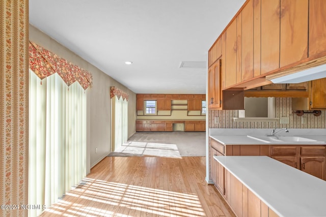 124 N Lisk Dr, Swansboro, NC 28584 - kitchen featuring backsplash, light wood-type flooring, a sink, light countertops, and recessed lighting