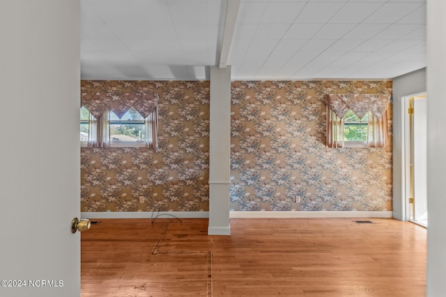 interior space with hardwood / wood-style floors and beamed ceiling