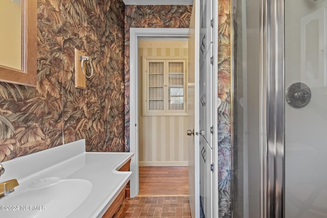 124 N Lisk Dr, Swansboro, NC 28584 - bathroom with baseboards, brick floor, vanity, and wallpapered walls