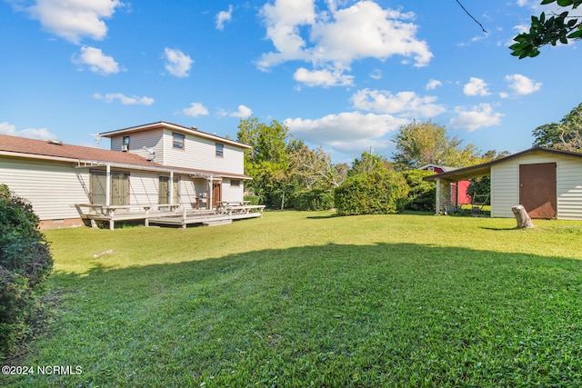 view of yard with a storage shed and a deck