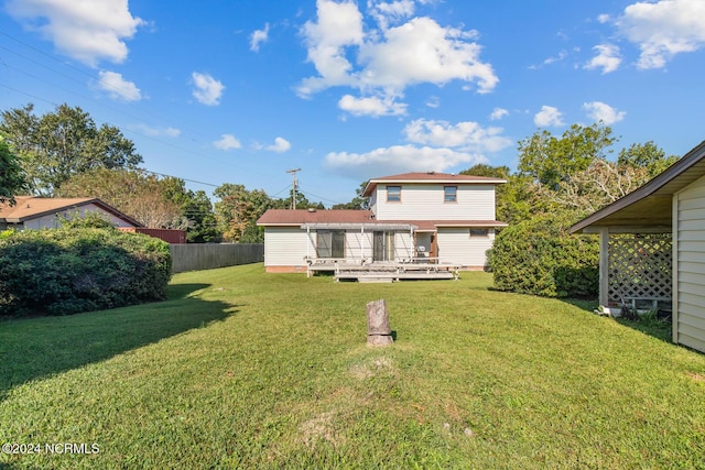 124 N Lisk Dr, Swansboro, NC 28584 - rear view of property featuring fence, a yard, and a deck