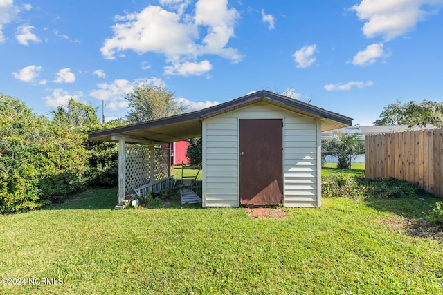 view of outbuilding with a yard