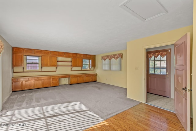 124 N Lisk Dr, Swansboro, NC 28584 - unfurnished living room featuring light wood-type flooring and attic access