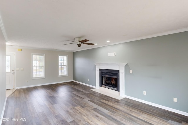 unfurnished living room featuring hardwood / wood-style floors, ceiling fan, and crown molding