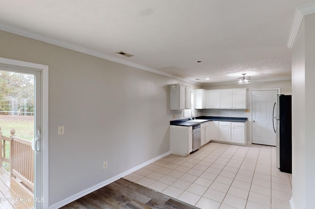 kitchen with white cabinetry, light wood-type flooring, appliances with stainless steel finishes, and crown molding