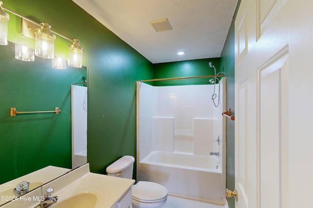 full bathroom featuring vanity, tub / shower combination, toilet, and a textured ceiling