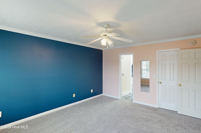 unfurnished bedroom with light colored carpet, ceiling fan, and crown molding