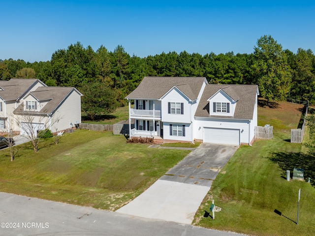 view of front of property featuring a garage, a porch, and a front lawn