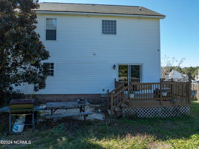 back of property featuring a wooden deck