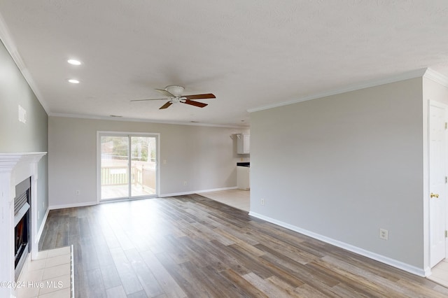 unfurnished living room featuring ceiling fan, light hardwood / wood-style flooring, and crown molding