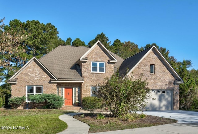 view of property with a front lawn and a garage