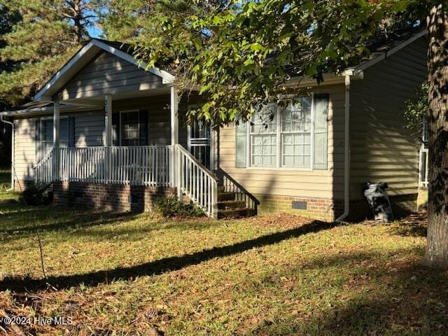 bungalow-style house featuring a porch and a front yard