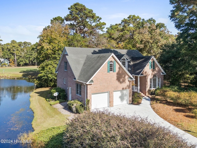 view of front facade featuring a garage and a water view