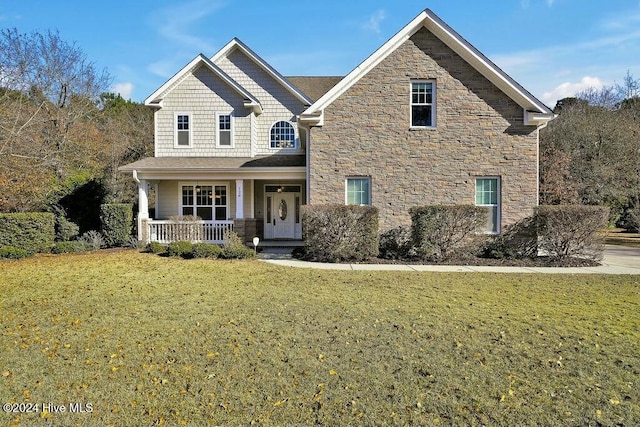 view of front of property featuring covered porch and a front yard