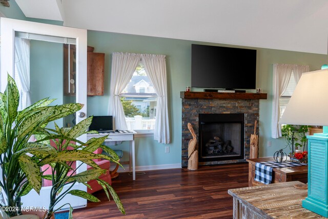 home office with a fireplace and dark hardwood / wood-style flooring