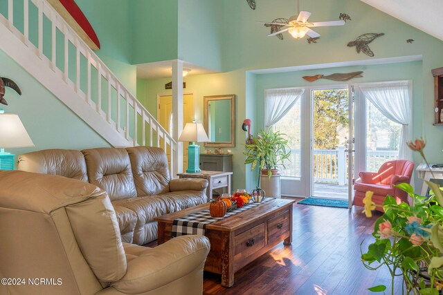 living room featuring dark wood-type flooring, high vaulted ceiling, and ceiling fan