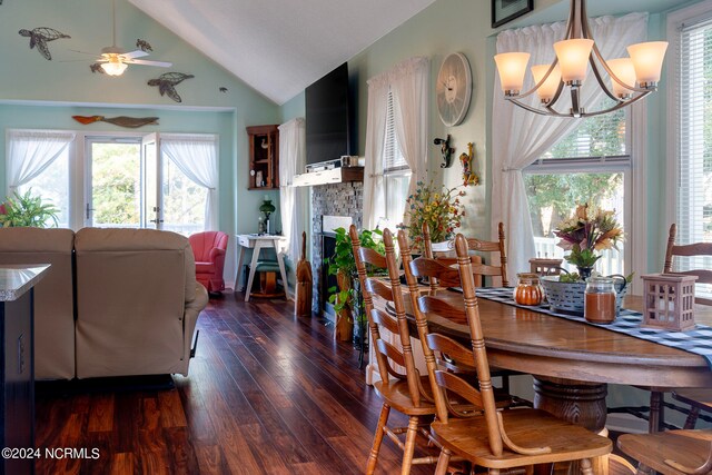 dining room featuring high vaulted ceiling, ceiling fan with notable chandelier, and dark hardwood / wood-style flooring