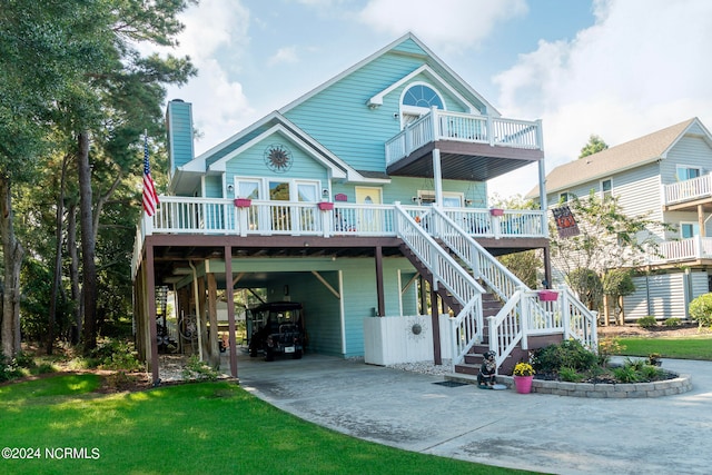 coastal home with a carport, a deck, and a front lawn