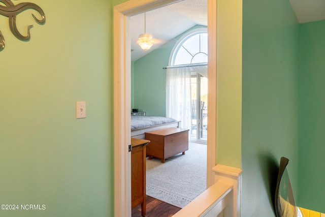 hall featuring vaulted ceiling and wood-type flooring