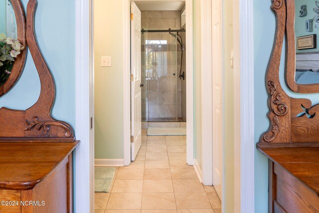 bathroom with tile patterned floors and an enclosed shower