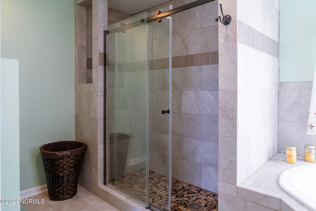 bathroom featuring independent shower and bath and tile patterned floors