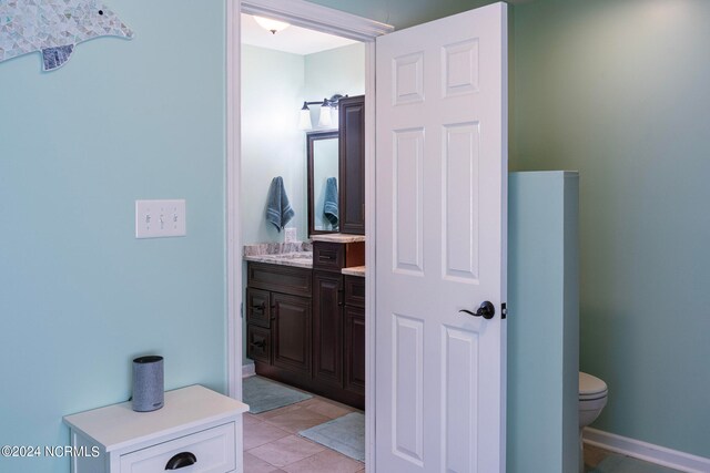 bathroom with vanity, toilet, and tile patterned floors