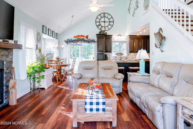 living room featuring ceiling fan, high vaulted ceiling, and dark hardwood / wood-style flooring