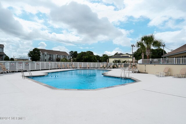 view of swimming pool with a patio