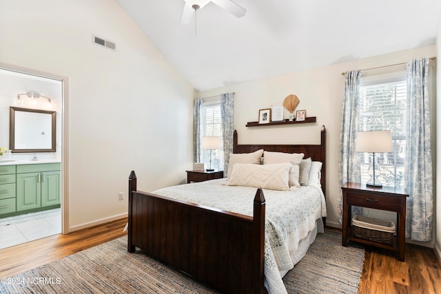 bedroom featuring ceiling fan, multiple windows, and hardwood / wood-style floors