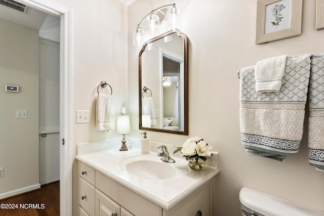 bathroom with vanity, hardwood / wood-style floors, and toilet