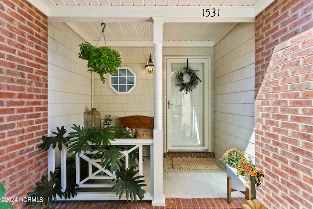 entrance to property featuring covered porch