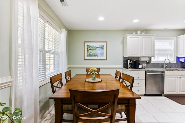 dining space featuring light tile patterned flooring and sink